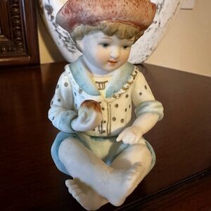 Andrea By Sadek Porcelain Boy Figurine with Red and Blue Accents